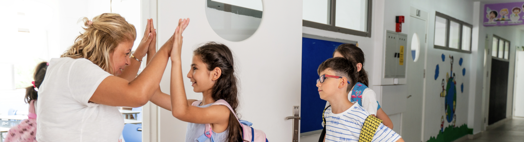 Happy teacher giving happy students a high five