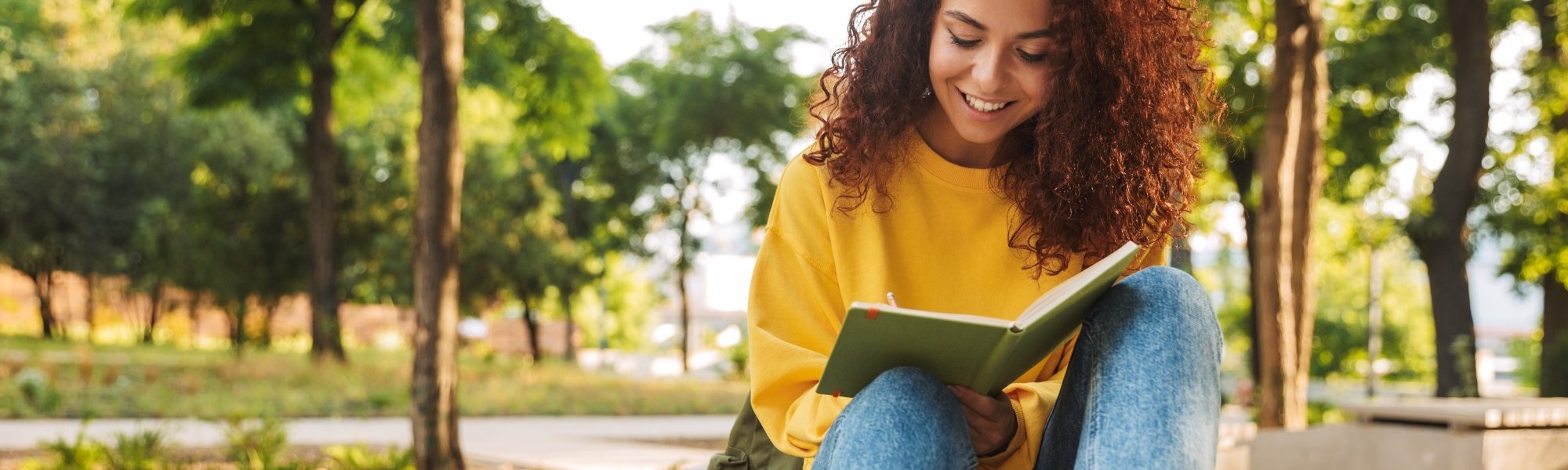 smiling student reading a book smiling student reading a book